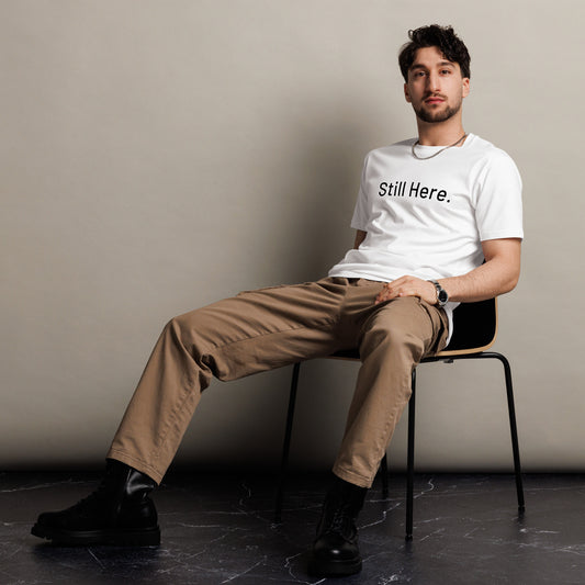 Still Here Co. white tee front view — minimalist resilience apparel