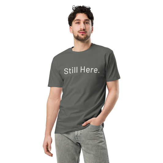 Still Here Co. unisex tee in charcoal — 'Still Here.' front text print